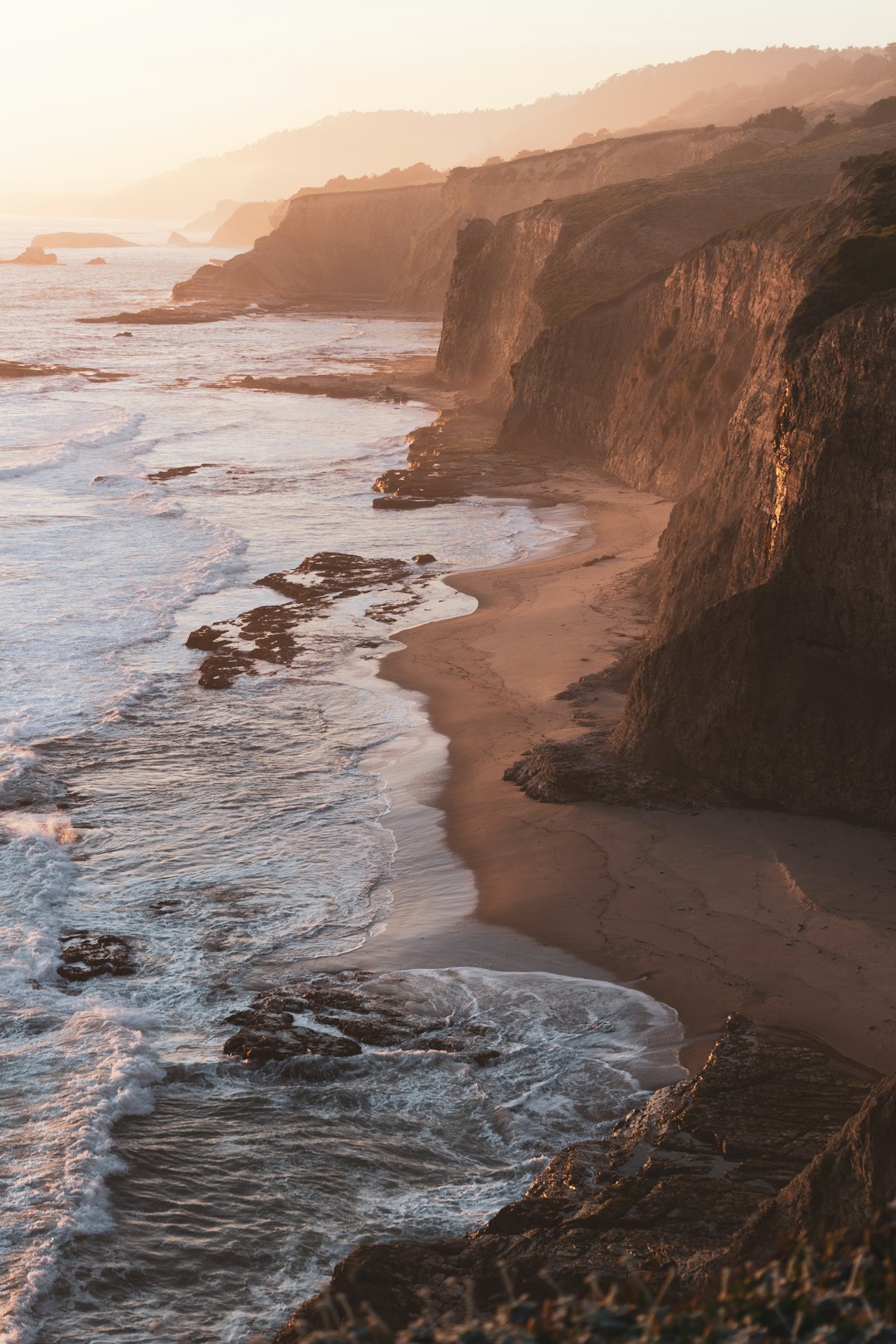 Sunset over a winding California coastline